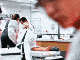 a person laying on a bed with blood on their clothes and a sign that says p