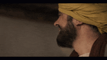 a man with a beard and a yellow turban