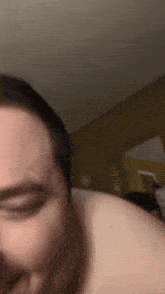 a man laying on a bed with his eyes closed and his mouth open