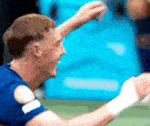 a man wearing a blue shirt with a white circle on the sleeve