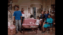 a group of people are standing in a living room