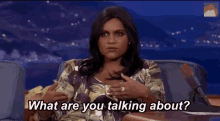 a man and a woman are sitting at a table and the woman is asking the man what are you talking about