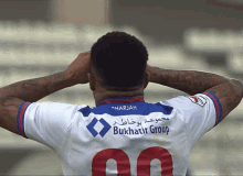 a soccer player wearing a shirt that says bukhatir group