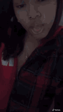 a close up of a woman 's face with a tiktok watermark on the bottom right