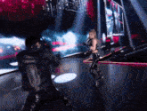 a man and woman are dancing on a stage .