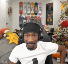 a man wearing headphones is sitting in a chair in front of a christmas tree