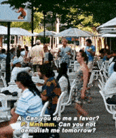 a group of people are sitting at tables and chairs in a restaurant .