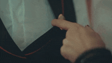 a close up of a person 's hand pressing a button on a device