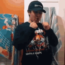 a young man wearing a hat and a shirt with the word evo on it