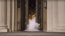 a woman in a bathing suit is coming out of a door
