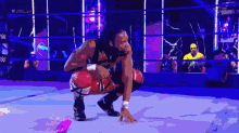 a wrestler is kneeling down in a wrestling ring with the hashtag # 205live