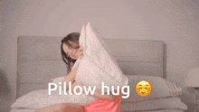 a woman is hugging a pillow with the words pillow hug written below her
