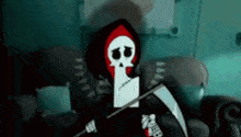 a grim reaper is sitting on a couch holding a scythe in a dark room .