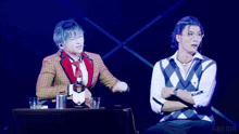 two men are sitting next to each other with the abema logo on the bottom right