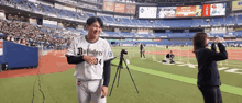 a man in a buffaloes jersey stands on the field