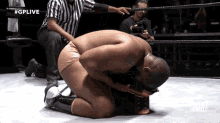 a wrestler is kneeling down in a ring with #gplive on the bottom