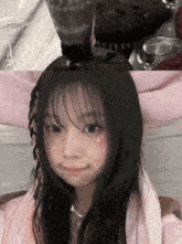 a girl with a tear on her cheek is making a face