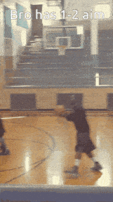 a person playing basketball on a court with the words bro has 1-2 aim