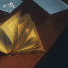 an open book on a table with a sherlock logo in the corner