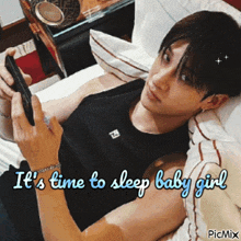 a man laying on a bed looking at a cell phone with the words it 's time to sleep baby girl below him