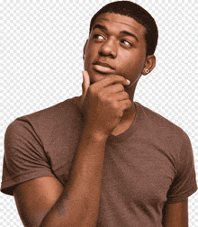 a man in a brown shirt has his hand on his chin looking up