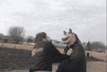 a man wearing a wolf mask holds another man