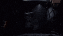 a dark room with smoke coming out of a doorway