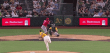 a baseball game is being played in front of budweiser advertisements
