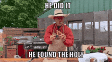 a man in a cowboy hat is holding a piece of meat with the words he did it he found the holy above him