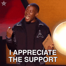 a man in a varsity jacket is giving a speech and says " i appreciate the support "