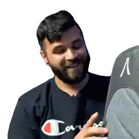 a man with a beard wearing a black shirt that says champion