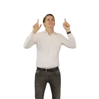 a man in a white shirt is pointing upwards with both hands