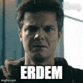 a close up of a man 's face with the word erdem written on his face
