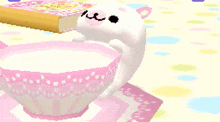 a pixel art of a rabbit drinking milk from a cup