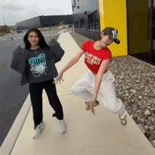 a woman wearing a red t-shirt that says i can drive your beach