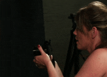 a woman with red nails and a ring on her finger takes a picture