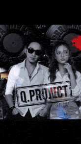 a man and a woman holding a sign that says q project