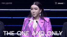 a woman in a purple suit is speaking into a microphone and the words the one and only are behind her