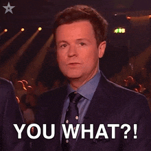 a man in a suit and tie says you what