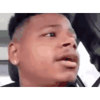 a man is making a funny face while sitting in the back seat of a car .