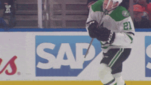 a hockey player with the number 21 on his jersey stands on the ice