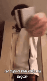 a person is standing in front of a door with the words leo dupa ce vede echipa lui bogdan written on the bottom