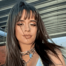a close up of a woman 's face with the words gif camilas at the top