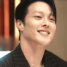 a close up of a man 's face with the name anneji written below it