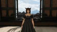 a woman in a black dress with a cat ear standing in front of a window