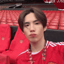 a man in a red manchester united jersey