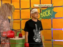 a man with a bandage on his head stands in front of a sign that says " sock "