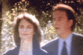 a man and a woman standing next to each other in a blurry photo