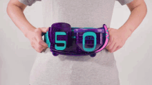 a person holding a purple belt with the number 50 on it