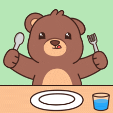 a teddy bear is sitting at a table with a plate and a glass of water